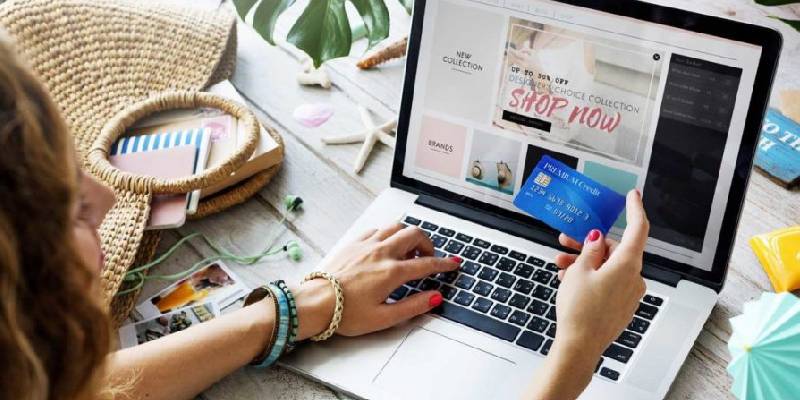 A Woman Purchasing GoodsIn Online By Using Her Credit Card.