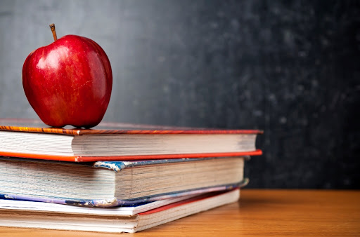 A Pile Of Books Placed On The Table - Education Concept.