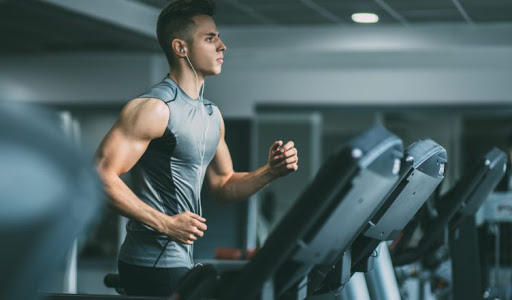 A Man Doing Workout In The Gym For Imroving His Fitness Level.